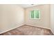 Bedroom featuring neutral walls, carpet, and window with view of trees at 5286 Westhill Dr, Norcross, GA 30071