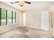 A sunlit bedroom with a ceiling fan and multiple windows at 5286 Westhill Dr, Norcross, GA 30071