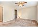 A view of a cozy bedroom with a ceiling fan and neutral color scheme at 5286 Westhill Dr, Norcross, GA 30071