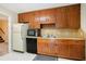 Kitchen area featuring wooden cabinets, stainless steel sink, and appliances at 5286 Westhill Dr, Norcross, GA 30071