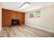 Spacious living room featuring wood-burning fireplace, wood accent wall, and natural light at 5286 Westhill Dr, Norcross, GA 30071