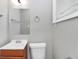 Bathroom featuring updated sink, toilet, and mirror with a view from the window at 3711 Daisy Dr, Decatur, GA 30032