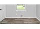 Neutral bedroom featuring wood-look flooring and natural light at 3711 Daisy Dr, Decatur, GA 30032