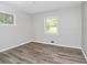 Bright bedroom featuring wood-look flooring, neutral paint, and natural light at 3711 Daisy Dr, Decatur, GA 30032