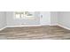 Bright bedroom with new flooring, fresh paint, large window, and a modern white door at 3711 Daisy Dr, Decatur, GA 30032