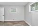 A bright bedroom featuring modern gray walls and wood floors at 3711 Daisy Dr, Decatur, GA 30032
