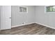 A bedroom featuring wood floors, modern gray walls, and a white door at 3711 Daisy Dr, Decatur, GA 30032