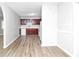 Bright, open-concept kitchen with dark wood cabinetry, white appliances, and wood-look flooring at 3711 Daisy Dr, Decatur, GA 30032