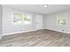 Bright living room featuring wood-look flooring, neutral paint, and natural light at 3711 Daisy Dr, Decatur, GA 30032