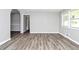 Bright and spacious living room boasting new flooring, fresh paint, and an arched doorway to other rooms at 3711 Daisy Dr, Decatur, GA 30032
