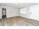 Inviting living room featuring new floors, fresh paint, windows, and a modern front door at 3711 Daisy Dr, Decatur, GA 30032