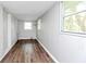 Bonus room or storage area featuring painted brick, wood-look flooring, and natural light at 3711 Daisy Dr, Decatur, GA 30032