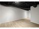 Finished basement with light wood flooring and painted white walls at 3765 Michaels Way, Cumming, GA 30040