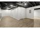 Finished basement space with exposed duct work and an interior access door at 3765 Michaels Way, Cumming, GA 30040
