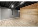 Finished basement space with exposed duct work and a decorative wood slat wall at 3765 Michaels Way, Cumming, GA 30040