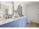 Bathroom featuring a double vanity, modern fixtures, and stylish blue cabinetry at 3765 Michaels Way, Cumming, GA 30040