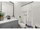 Well-lit bathroom features a gray vanity and a shower with a floral shower curtain at 3765 Michaels Way, Cumming, GA 30040