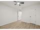 Bright bedroom with a ceiling fan and wood-look floors with multiple doors at 3765 Michaels Way, Cumming, GA 30040