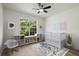 Bright Bedroom featuring a large window, hardwood floors, and a modern ceiling fan at 3765 Michaels Way, Cumming, GA 30040