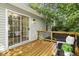 Cozy deck with wood flooring and sliding door access, offering views of surrounding trees at 3765 Michaels Way, Cumming, GA 30040