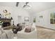 A cozy living room featuring a stone fireplace, wood floors, and neutral-toned furniture at 3765 Michaels Way, Cumming, GA 30040