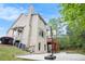 Backyard view featuring a basketball hoop, multi-level deck, patio, and lush landscaping at 3907 Fellowship Dr, Buford, GA 30519