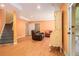 Finished basement featuring hardwood floors, a leather sofa, and access to the backyard at 3907 Fellowship Dr, Buford, GA 30519