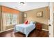This cozy bedroom features laminate floors, one window, and natural colored walls at 3907 Fellowship Dr, Buford, GA 30519