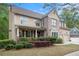 Charming two-story home with a well-manicured lawn, a two-car garage, and a covered front porch at 3907 Fellowship Dr, Buford, GA 30519