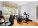 Home gym with various fitness equipment, natural light from the windows, and hardwood flooring at 3907 Fellowship Dr, Buford, GA 30519