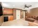 A living room featuring a plush sofa, and built-in wooden cabinets with a black mini-fridge beneath at 3907 Fellowship Dr, Buford, GA 30519