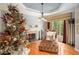 Cozy living room with hardwood floors, fireplace, and bright natural light from large picture window at 3907 Fellowship Dr, Buford, GA 30519