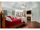 Spacious main bedroom features a fireplace, hardwood floors, and a tray ceiling with ceiling fan at 3907 Fellowship Dr, Buford, GA 30519