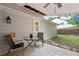 Covered back patio has fan, outdoor lighting, table, and chairs overlooking backyard at 1899 Cooper Landing Se Dr, Smyrna, GA 30080