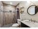 Bathroom features grey wood-look tile in shower with mosaic accents and granite countertop sink at 1899 Cooper Landing Se Dr, Smyrna, GA 30080