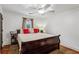 Comfortable bedroom featuring a large bed, hardwood floors, and ceiling fan at 1899 Cooper Landing Se Dr, Smyrna, GA 30080