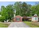 The home features a brick facade and a well-maintained front yard with mature trees at 1899 Cooper Landing Se Dr, Smyrna, GA 30080