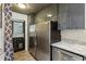 Kitchen with stainless steel appliances, gray cabinets, granite counters, and a back door at 1899 Cooper Landing Se Dr, Smyrna, GA 30080