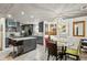 Modern kitchen with stainless steel appliances, gray cabinets, island seating, and a glass table at 1899 Cooper Landing Se Dr, Smyrna, GA 30080