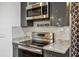 Modern kitchen with stainless steel appliances, gray cabinets, and white tile backsplash at 1899 Cooper Landing Se Dr, Smyrna, GA 30080