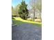 Green backyard featuring a concrete patio, lush grass, and mature trees at 2896 Spence Ct, Dacula, GA 30019