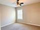 Cozy bedroom featuring a ceiling fan, neutral paint, and a bright window at 2896 Spence Ct, Dacula, GA 30019