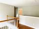 Upstairs hallway area with white railing and wood floors, connecting various rooms at 2896 Spence Ct, Dacula, GA 30019