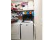 Functional laundry area with washer, dryer, and shelving for storage at 2896 Spence Ct, Dacula, GA 30019