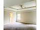 Spacious main bedroom with tray ceiling, ceiling fan and doorway to the adjoining bathroom at 2896 Spence Ct, Dacula, GA 30019