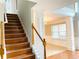 Elegant staircase leading to the second floor with wood steps and white railing at 2896 Spence Ct, Dacula, GA 30019
