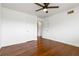 Open bedroom with hardwood floors, a ceiling fan, and two white doors at 3046 Briarcliff Ne Rd # 7, Atlanta, GA 30329
