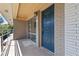 Apartment entryway featuring a blue door, brick wall, and covered porch area at 3046 Briarcliff Ne Rd # 7, Atlanta, GA 30329