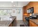 Well-lit kitchen with granite countertops and stainless steel appliances with a view of the trees at 3046 Briarcliff Ne Rd # 7, Atlanta, GA 30329