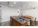 Charming kitchen island with stainless steel sink and granite countertops near a wooden dining table at 3046 Briarcliff Ne Rd # 7, Atlanta, GA 30329